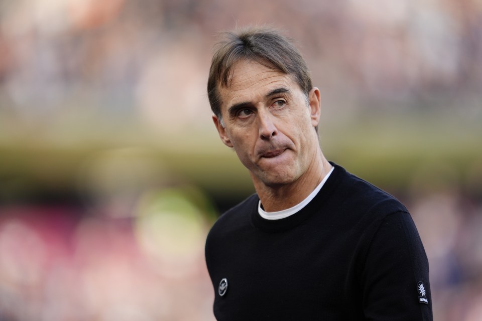 a man wearing a black sweater with a white logo on the sleeve