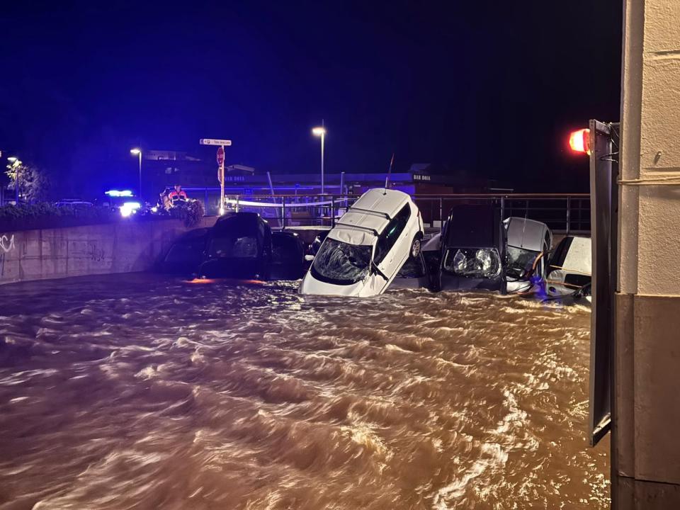 a flooded area with a white car in the middle
