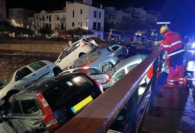a bunch of cars are stacked on top of each other and one of them has a license plate that says jcj 973
