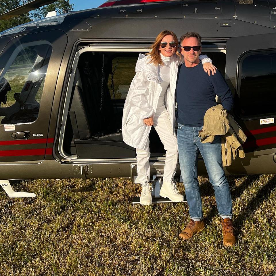 Geri Horner Halliwell and a man standing by a helicopter.