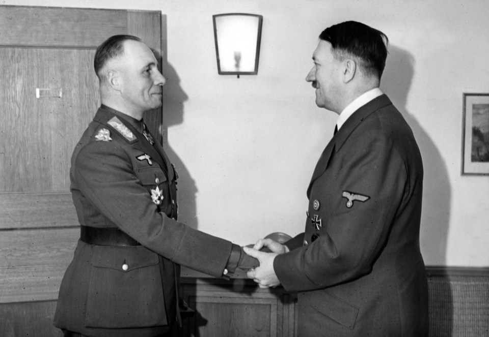 a black and white photo of two men shaking hands