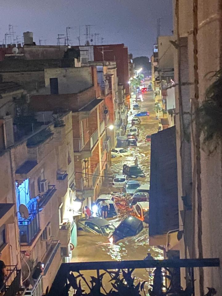 a flooded street with a lot of cars in the water