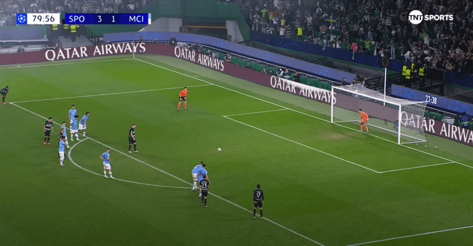 a soccer field with qatar airways advertisements on the sidelines