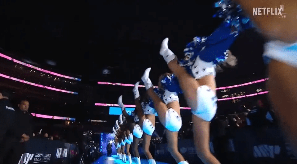 cheerleaders perform in front of a sign that says netflix
