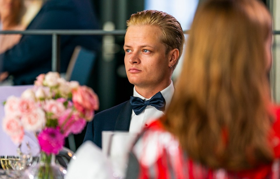 Man in a tuxedo at a formal event.