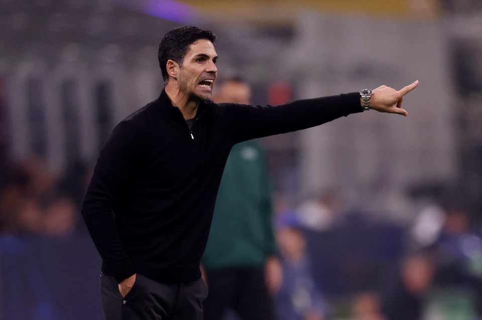 a man in a black sweater is pointing at something