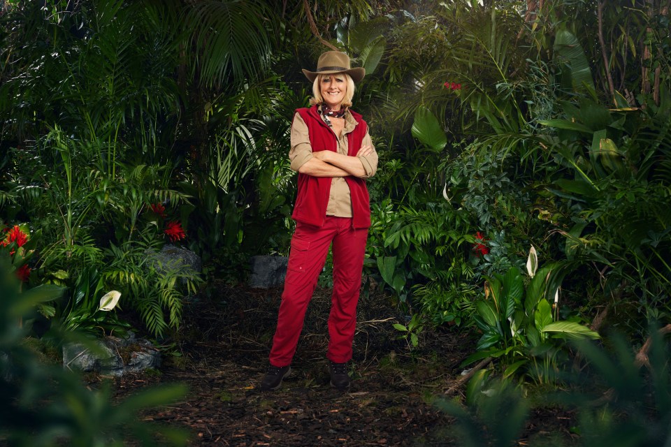 a woman in a jungle with her arms crossed
