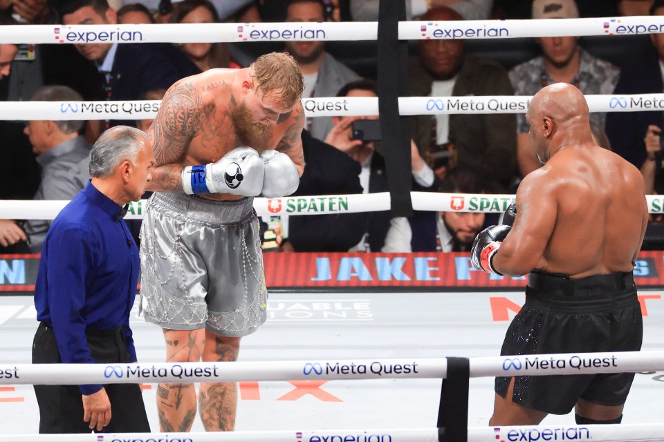two boxers are standing in a boxing ring sponsored by meta quest