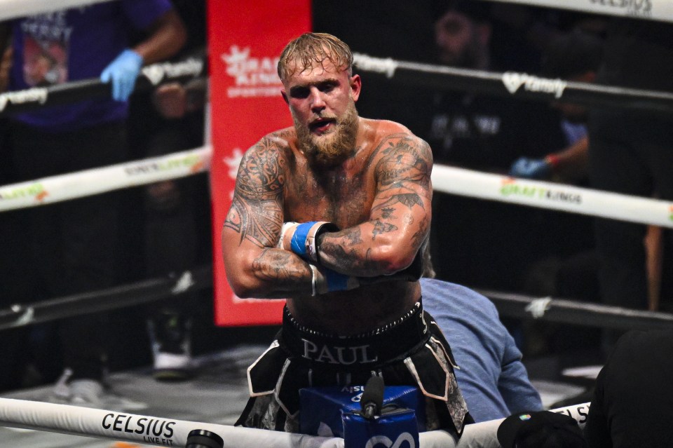 a man in a boxing ring with paul on his shorts