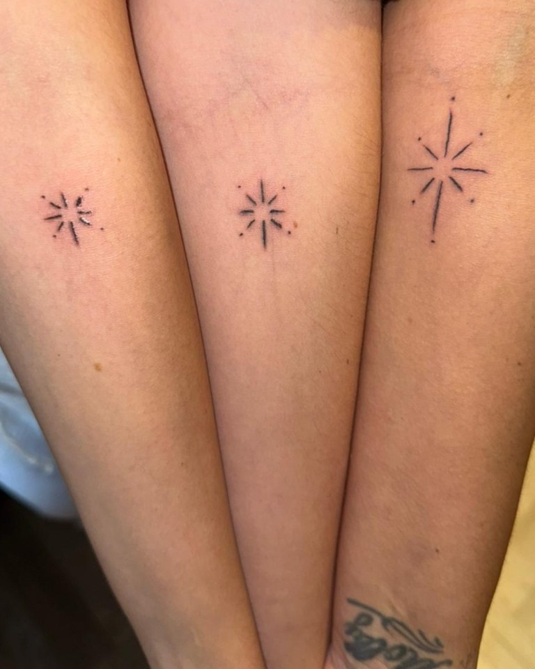 three people have small stars on their forearms