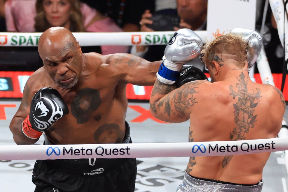 two boxers in a ring with meta quest on the ropes