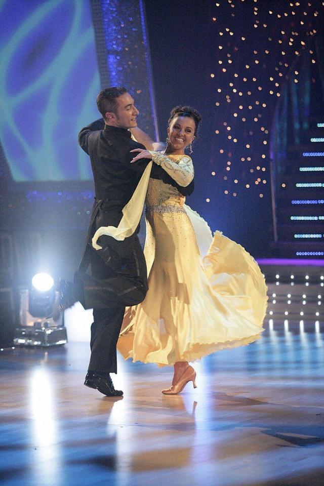 a man and a woman are dancing on a dance floor