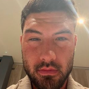 a close up of a man with a beard taking a selfie .