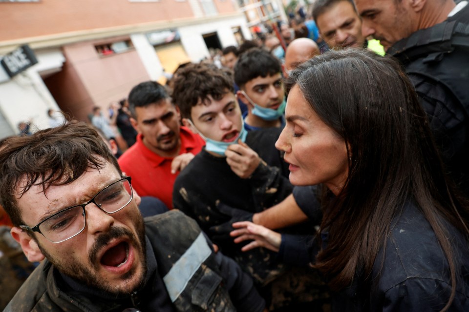 a crowd of people are gathered in front of a store that says free