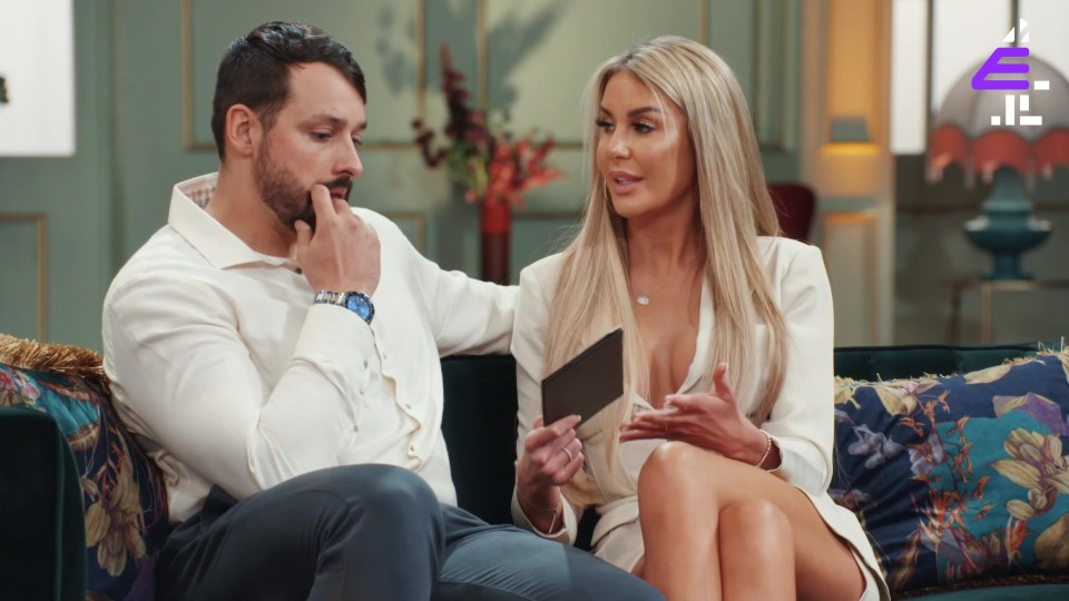 a man and a woman are sitting on a couch with the letters e on the bottom