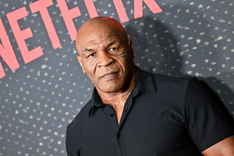 mike tyson stands in front of a netflix sign