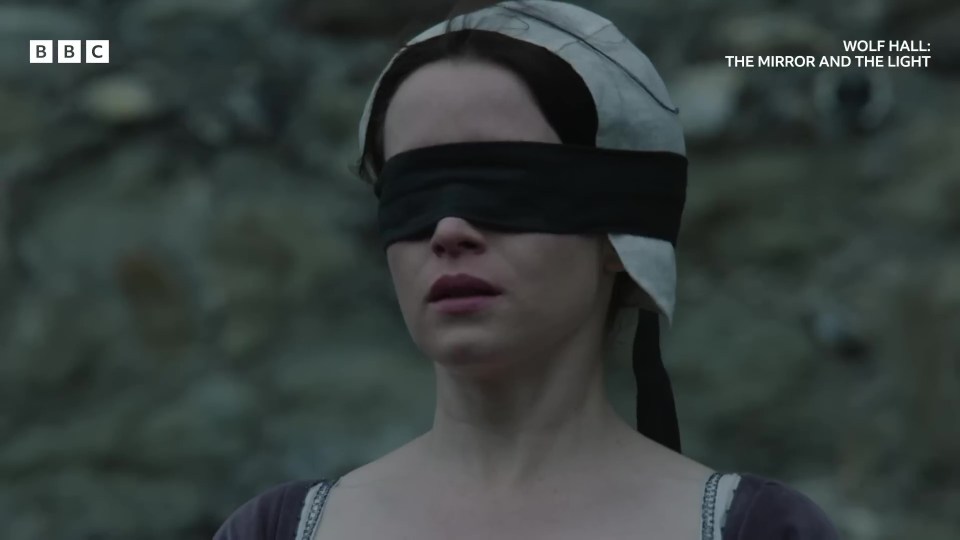 a woman is blindfolded in a scene from wolf hall
