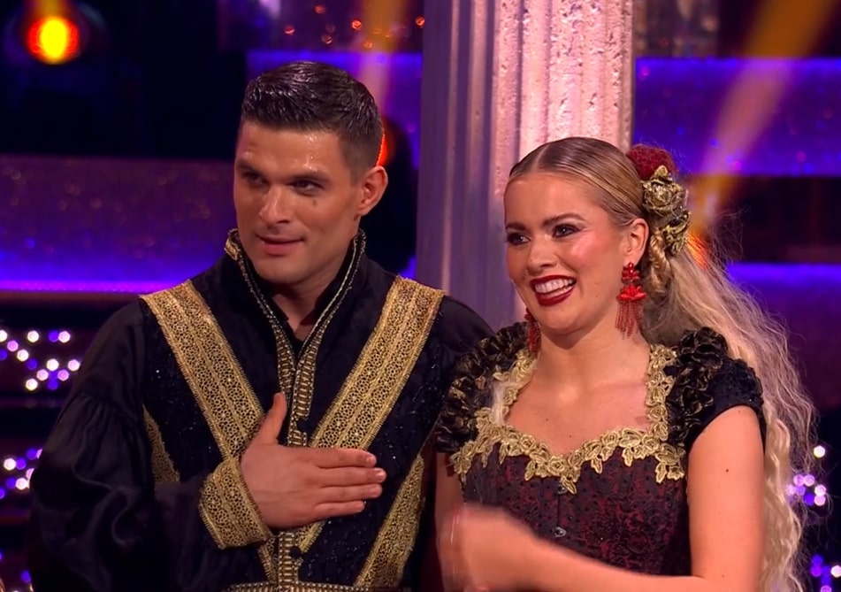 a man and a woman standing next to each other on a stage