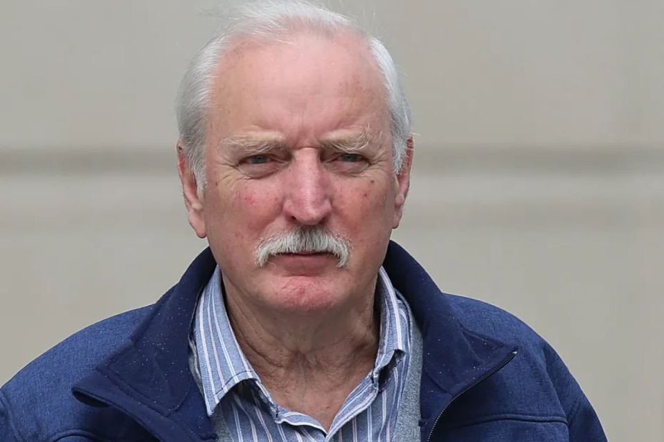 a man with gray hair and a mustache is wearing a blue jacket
