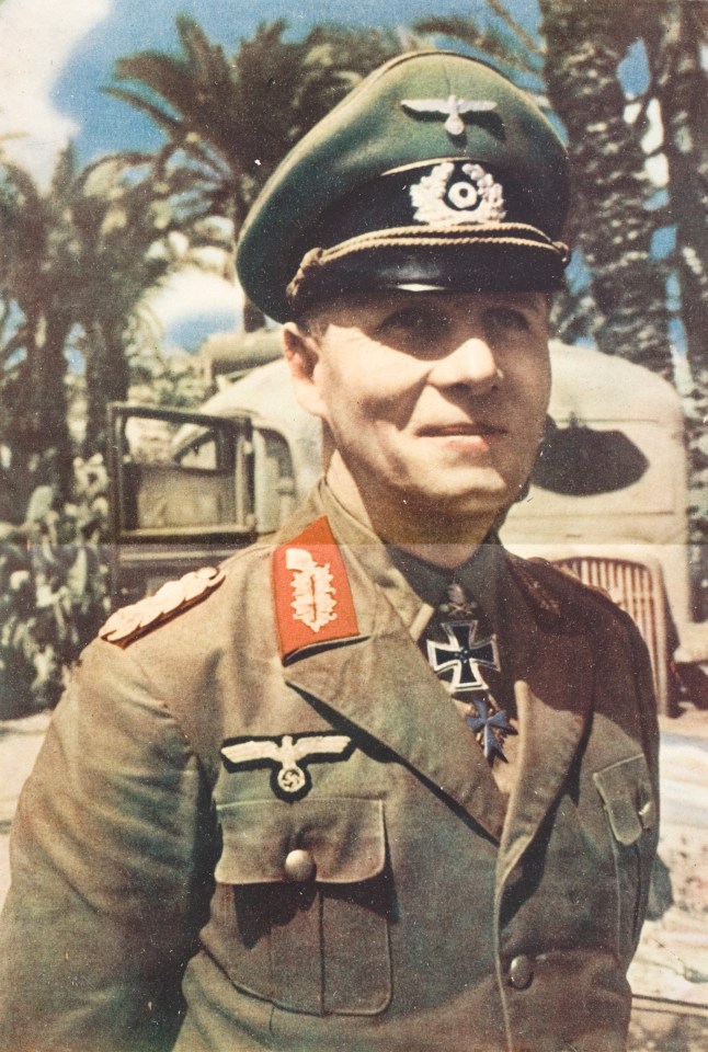 a man in a military uniform has a cross on his chest