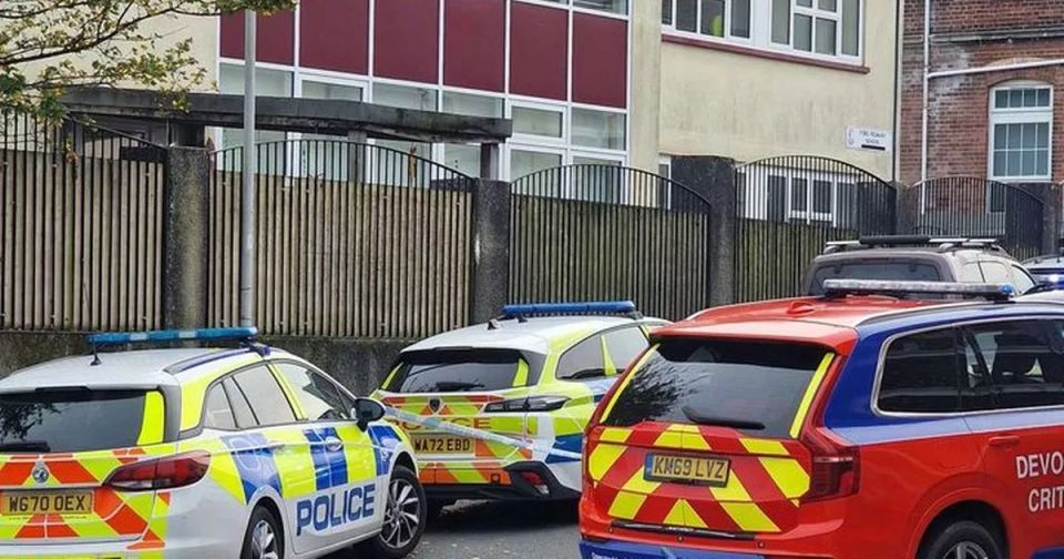 several police cars are parked in front of a building