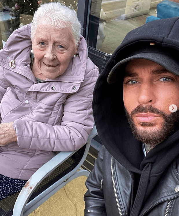 a man with a beard is posing for a picture with an elderly woman