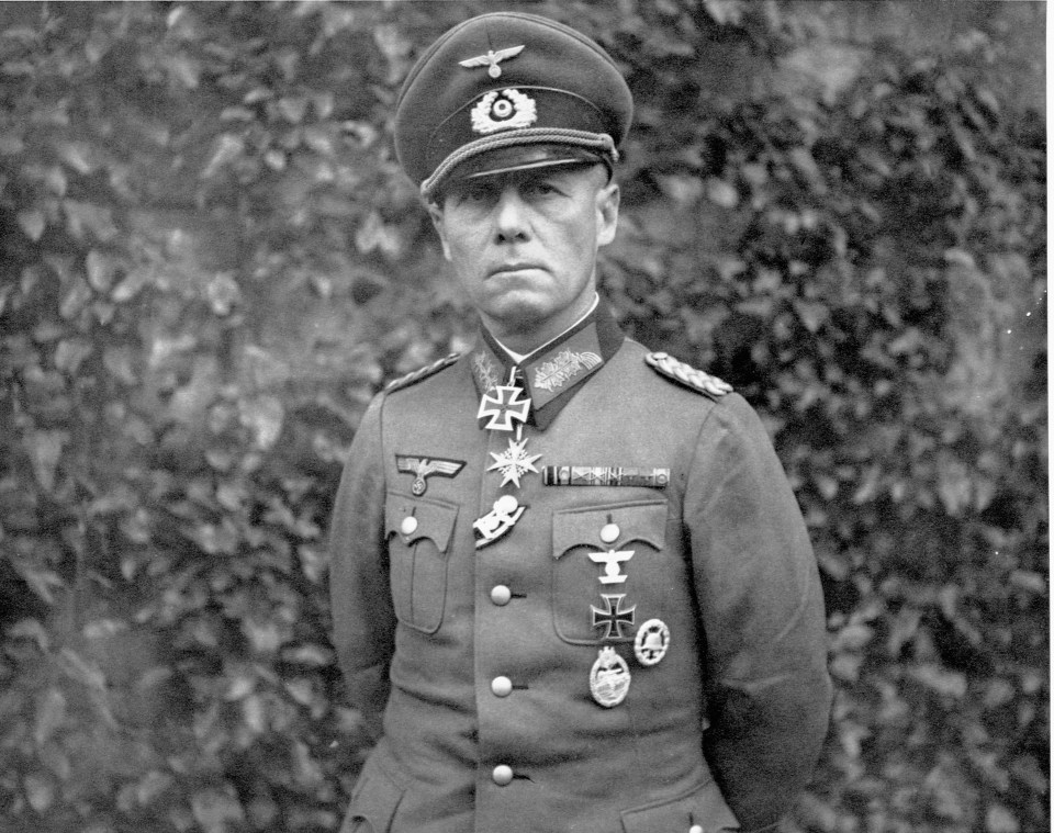 a black and white photo of a man in a military uniform