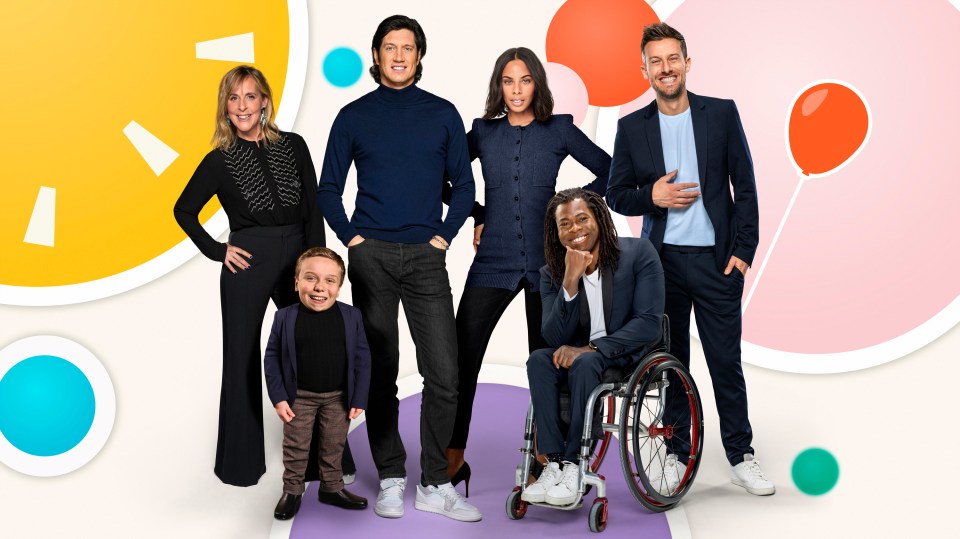 a group of people including a man in a wheelchair are posing for a picture