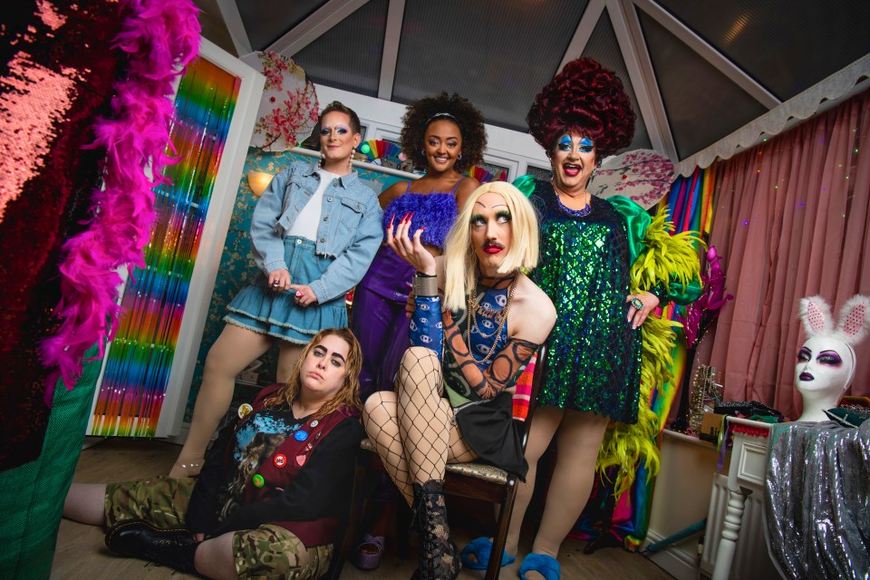 a group of drag queens are posing for a picture