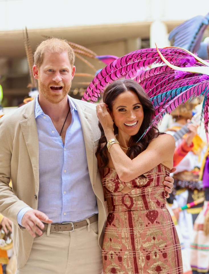 prince harry and meghan markle pose for a photo