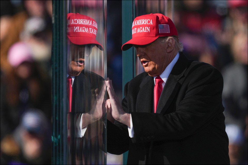 a man wearing a red hat that says america again