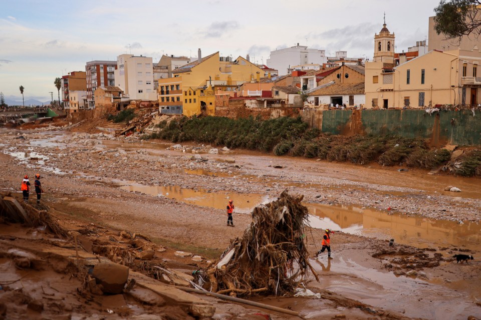 a flooded area with a church in the background