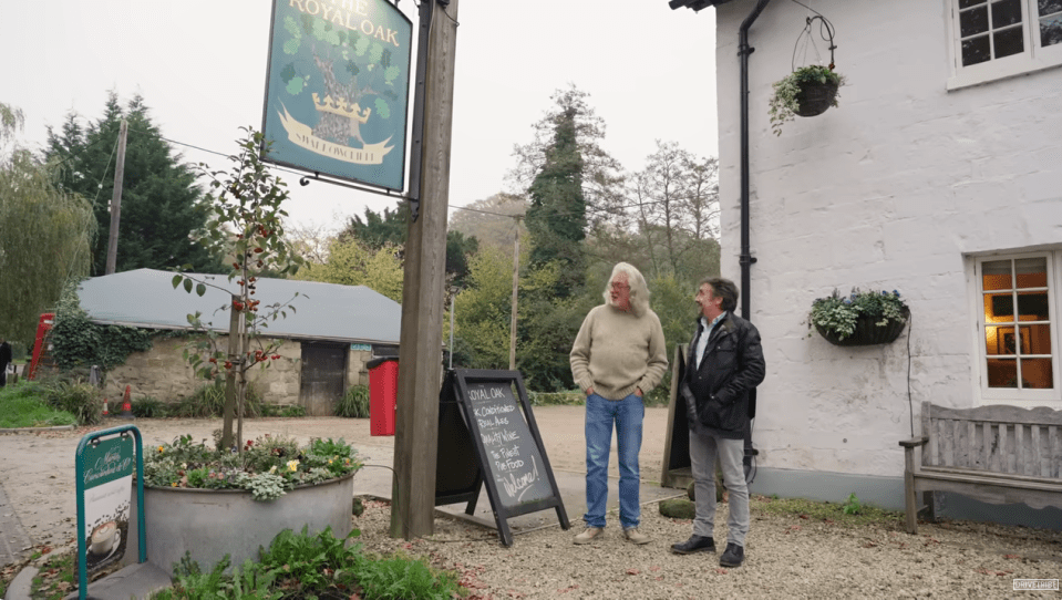 two men standing in front of a sign for the royal oak