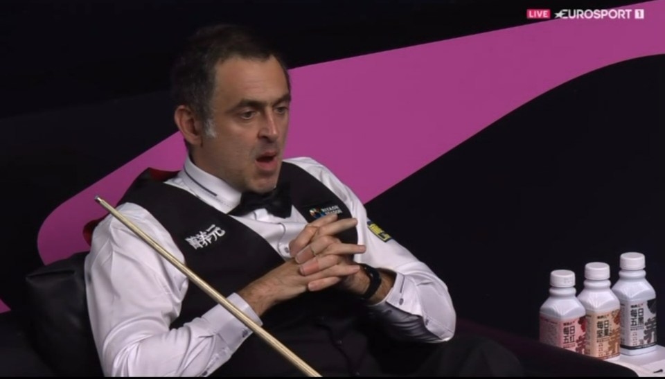 a man holding a cue in front of a eurosport logo