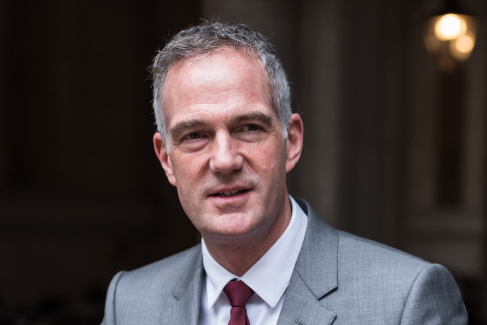 a man in a suit and tie looks at the camera
