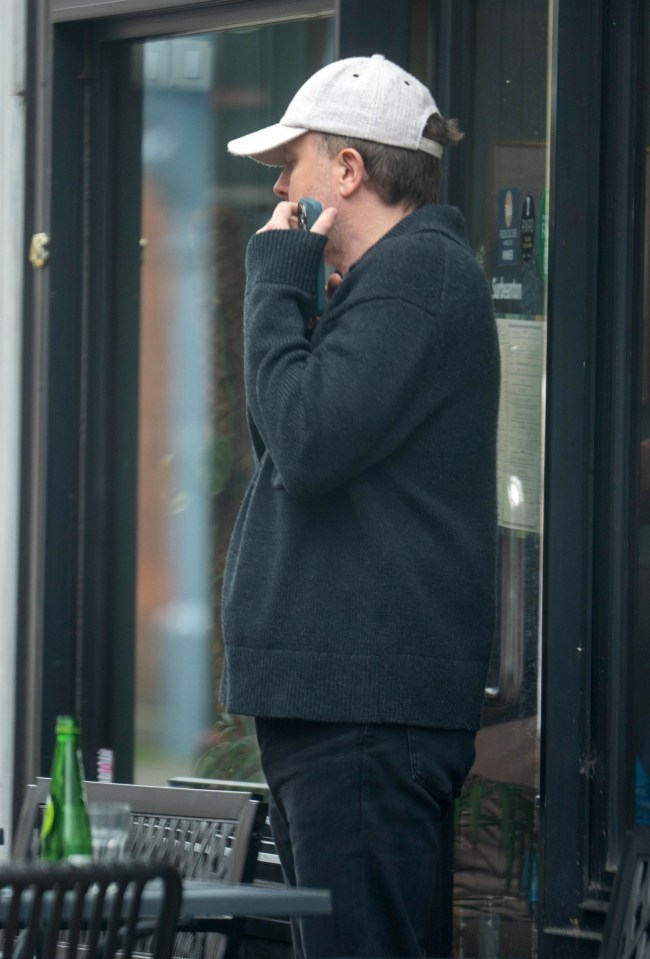 The comic held his phone in his hand as he waited outside