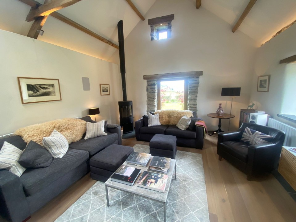 a living room with a couch and two chairs