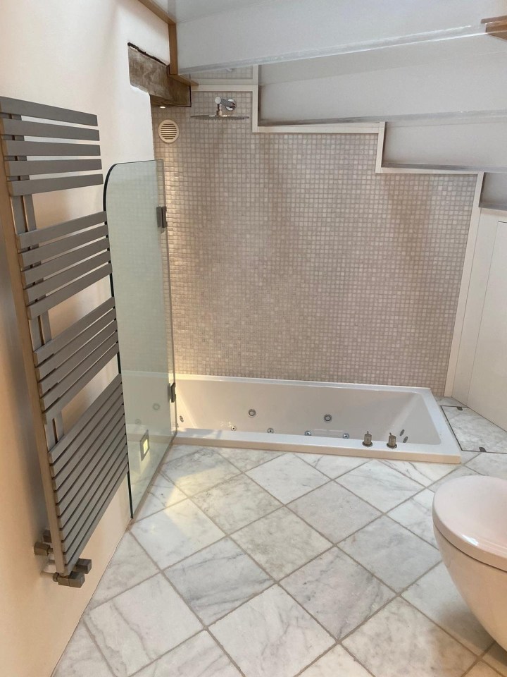 a bathroom with a bathtub and a towel rack