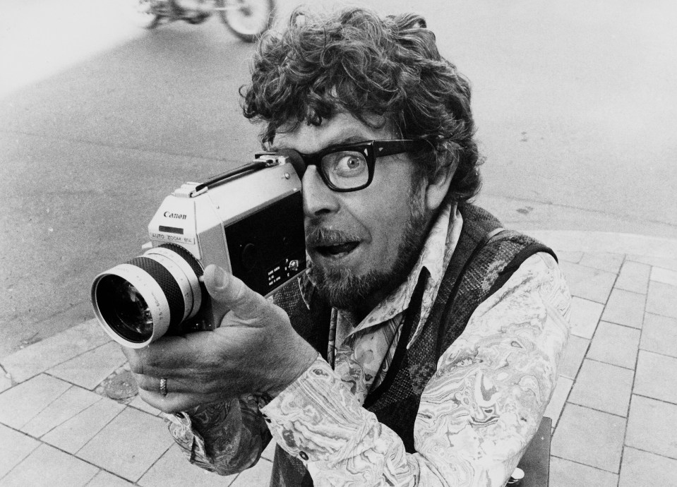 a man taking a picture with a canon camera