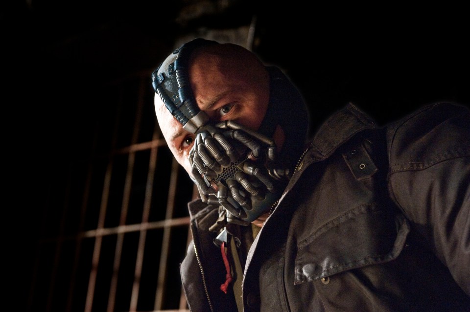 a man with a mask on his face looks down