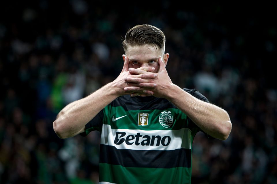a man in a betano jersey covers his face with his hands