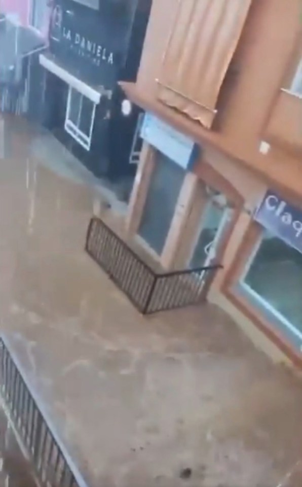 an aerial view of a flooded shopping mall with a staircase leading to a store .