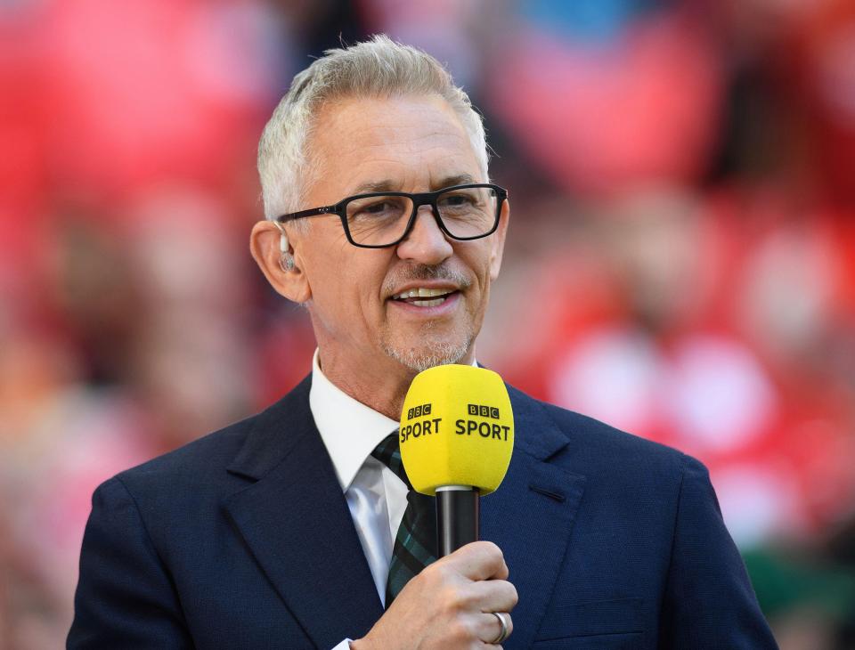 a man in a suit holds a yellow microphone that says bbc sport