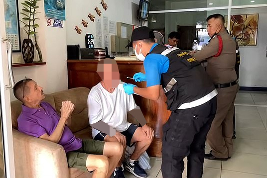 A British tourist being questioned by Thai police.