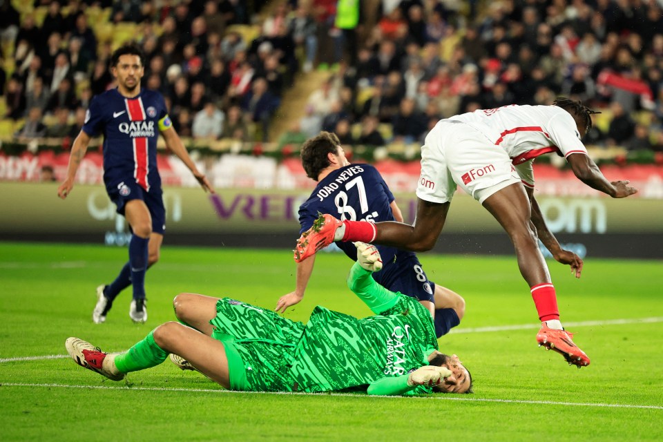 A soccer goalie is injured after being hit by a player jumping in the air.