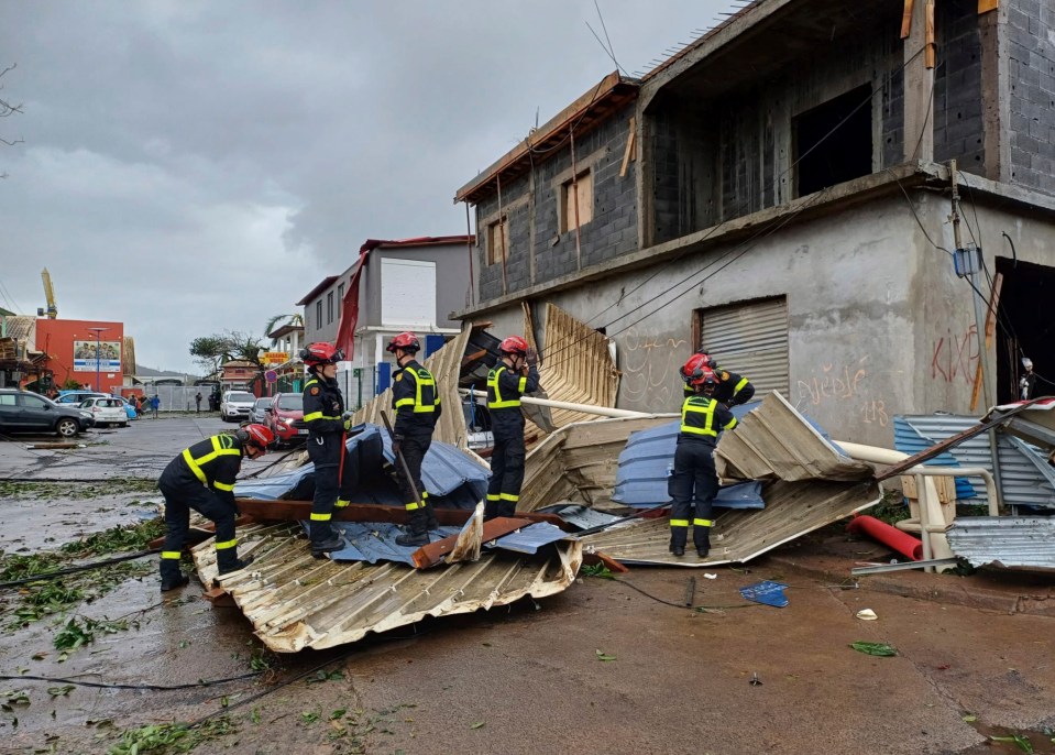 Rescue workers clearing debris after a cyclone in Mayotte.