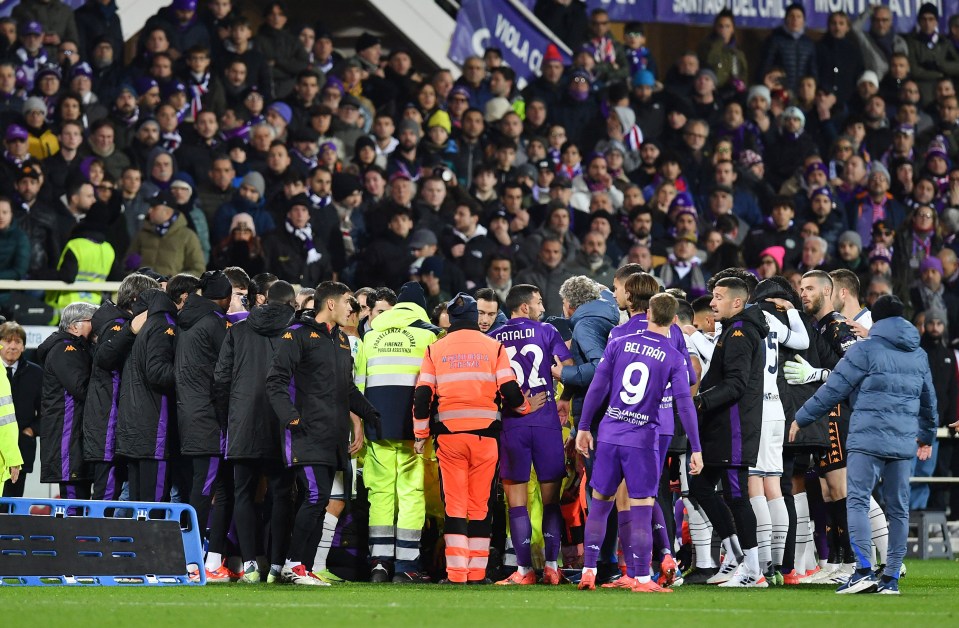 Fiorentina's Edoardo Bove receives medical attention on the field.