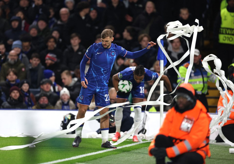 Chelsea players removing ribbon from the field.