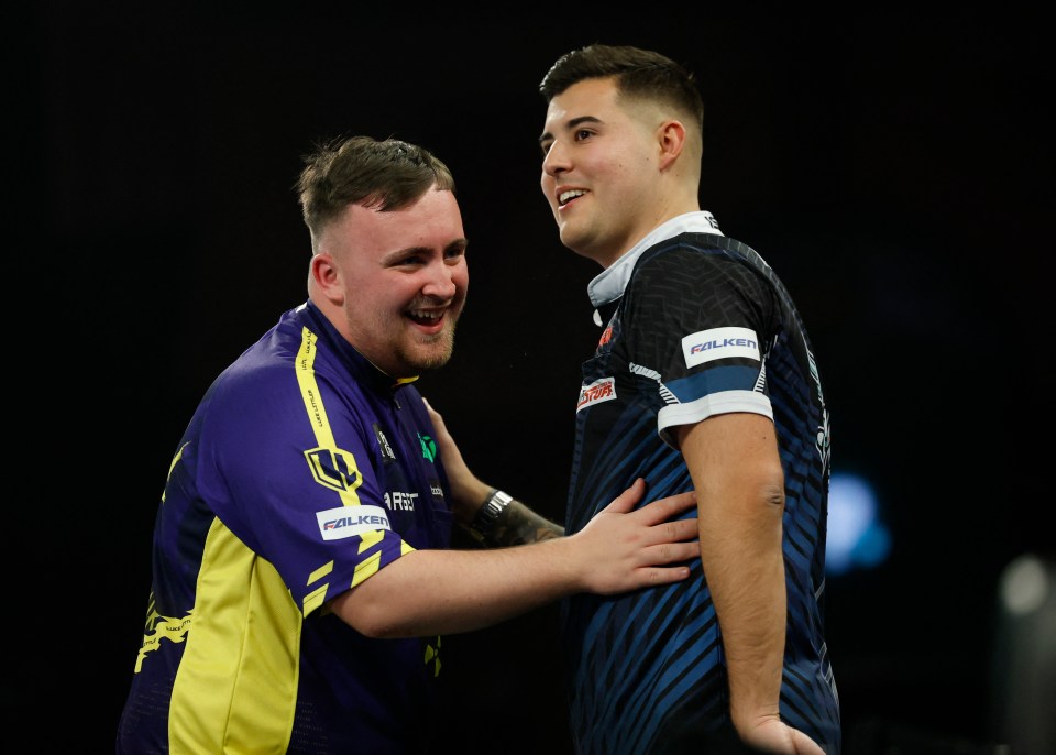 Luke Littler celebrates a darts match win.