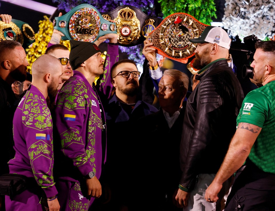 Usyk and Fury face off at a boxing weigh-in.